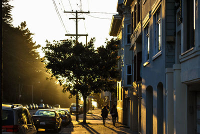 People walking on sidewalk in city