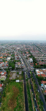 High angle view of road amidst buildings against sky