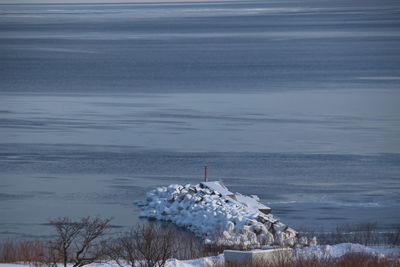 High angle view of sea against sky during winter