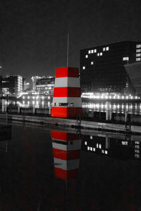 Red flag against buildings in city at night