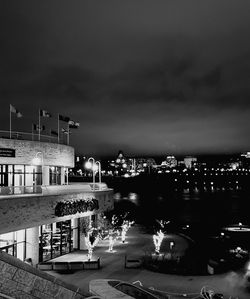 High angle view of illuminated buildings against sky at night