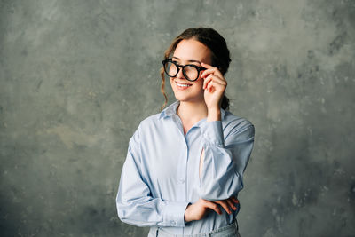 Smiling businesswoman in office. cheerful young woman in glasses, smiling and laughing while