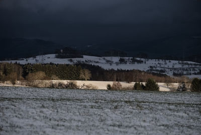 Scenic view of field against sky during winter