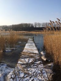 Scenic view of frozen lake against clear sky
