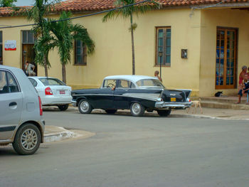 Cars parked on street by building