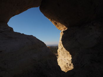 Low angle view of rock formation against sky