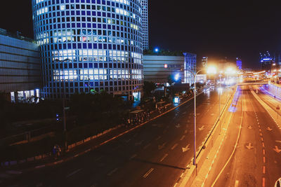 Illuminated city street and buildings at night