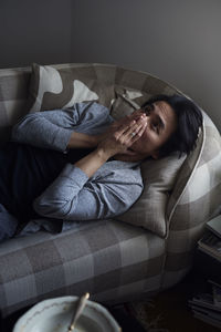 Man facing depression with hands covering his face