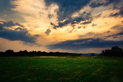 Scenic view of field against sky during sunset