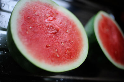 High angle close-up of watermelon on wet kitchen counter