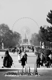 People in town square against sky