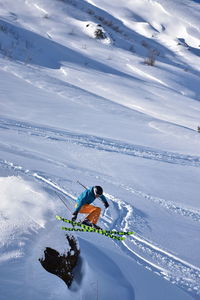 High angle view of man skiing on snow covered mountain