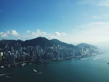 View of cityscape against cloudy sky