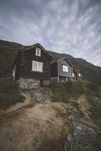 Houses by river and buildings against sky