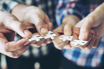 Close-up of hands holding people