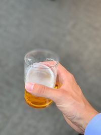 Midsection of man holding beer glass