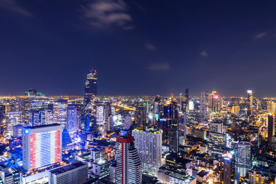 Illuminated cityscape against sky at night