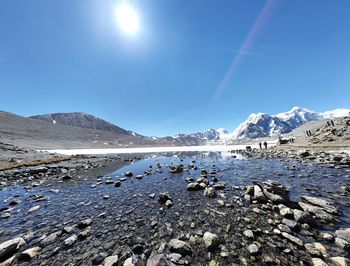 Scenic view of lake against clear blue sky