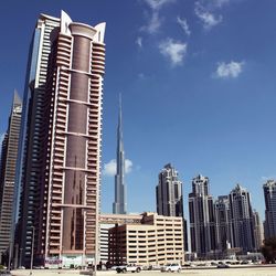 Low angle view of buildings against blue sky