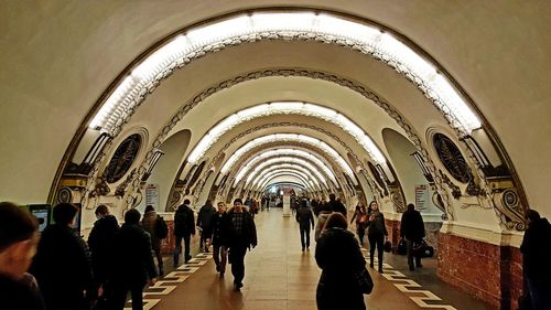 People in illuminated tunnel