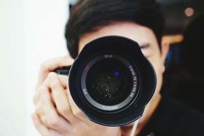 Close-up of man photographing with camera