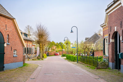 Footpath amidst buildings in city