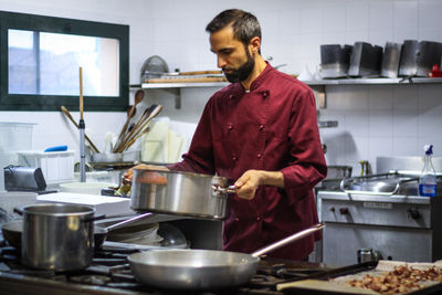 Man preparing food in kitchen at home