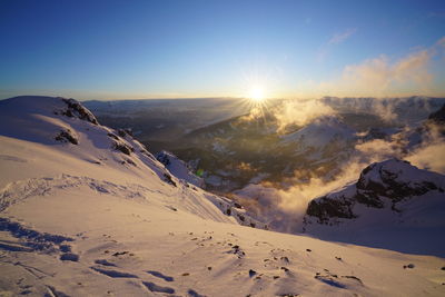 Scenic view of mountains against clear sky during sunset