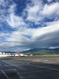 Airplane on runway against sky