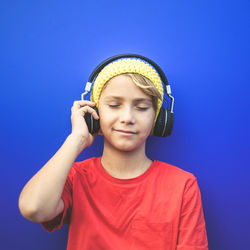 Portrait of cute boy against blue sky