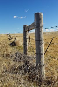 Fence on field against sky