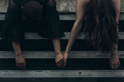 Low section of couple sitting on floor