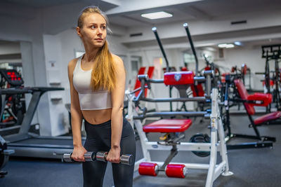 Young woman exercising in gym