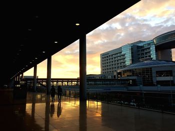 Buildings against cloudy sky at dusk