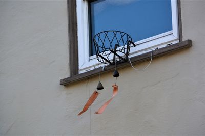 Low angle view of basketball hoop against wall