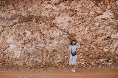 Portrait of woman standing on rock