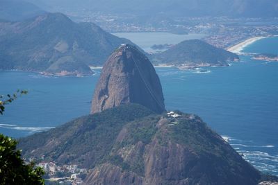 High angle view of sea and mountains against sky