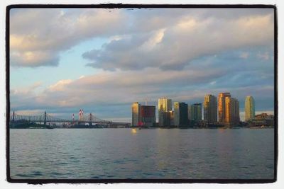 Cityscape against cloudy sky