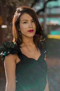 Portrait of young woman standing outdoors