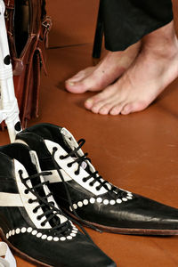 Low section of man sitting on tiled floor