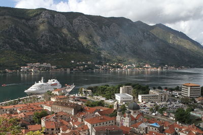 Aerial view of townscape by lake against sky