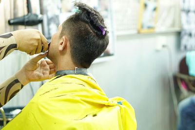 Close-up of barber shaving customers beard