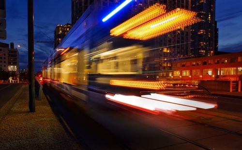 Blurred motion of train in illuminated city at night