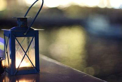 Close-up of illuminated lantern on table