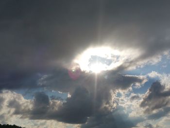 Low angle view of sun shining in sky