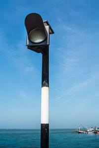 Lifeguard hut on sea against sky