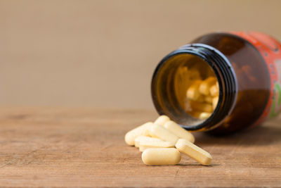 Close-up of pills and bottle on table