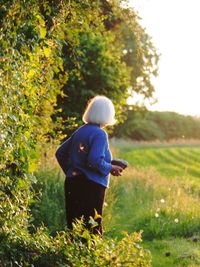 Senior woman standing on field