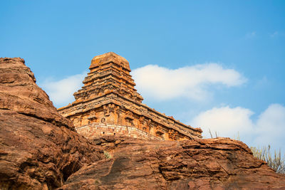 Low angle view of rock formations against blue sky