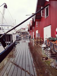 Pier amidst buildings in city against sky